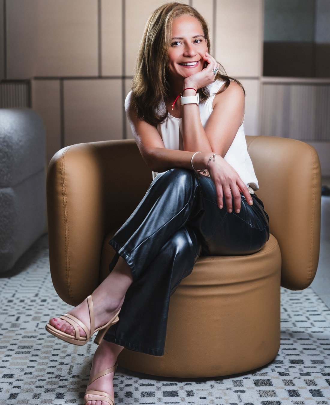 Maria Fernanda Crespo seated in a relaxed professional setting